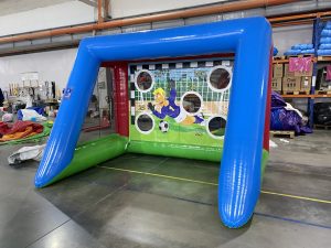 Children playing with inflatable football goals at a birthday party by Wild Atlantic Bouncy Castles